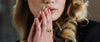 Loretana model close-up hands with 925 silver emerald ring and green bracelet, interchangeable hoop mechanism. Hallmarked piece from Kaunas atelier.