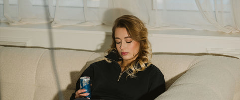 Loretana model lifestyle on cream sofa with Baltic light wearing fine jewelry, day to night styling. Hand-finished 925 sterling silver, Kaunas.