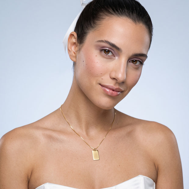 Model wearing the Engraved Square Necklace in 14K gold-plated 925 sterling silver