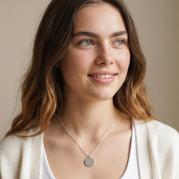 Model wearing the Engraved Coin Necklace in 925 sterling silver
